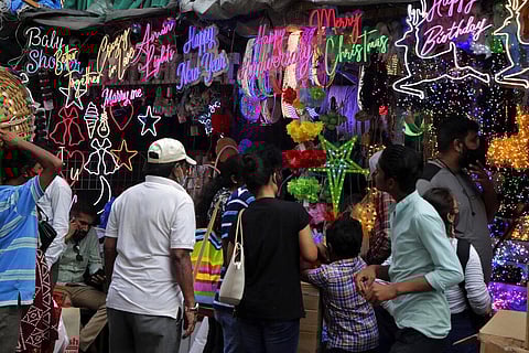 Shoppers crowd outside a souvenir shop selling decorative items ahead of the Christmas in Mumbai, India, Wednesday, Dec. 22, 2021. (Photo | AP)