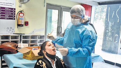 A health worker takes swab sample for Covid-19 test in New Delhi. (Photo | Shekhar Yadav)