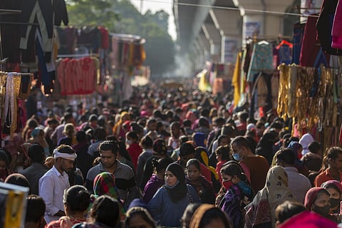 Indians, some wearing face masks as a precaution against the COVID-19, crowd a weekly market in New Delhi, India, Wednesday, Dec. 29, 2021. (Photo | AP)