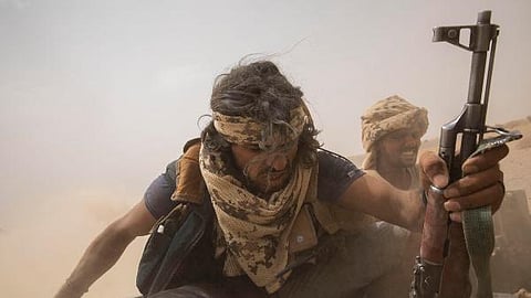 Yemeni fighters backed by the Saudi-led coalition ride on the back of an armored vehicle as they leave the front lines of Marib, Yemen.
