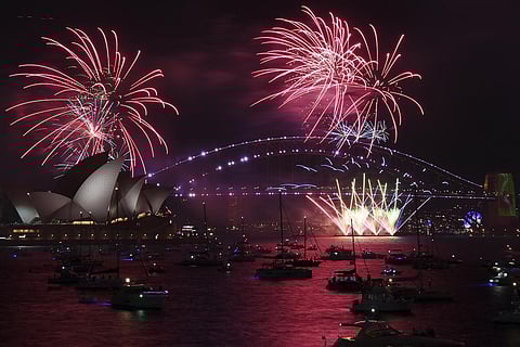 Fireworks explode over the Sydney Opera House and Harbour Bridge as New Year's Eve celebrations begin in Sydney, Friday, Dec. 31, 2021. (Photo | AP)
