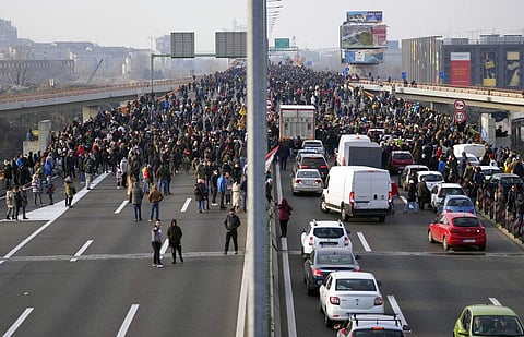 Protesters stand on the highway during a protest in Belgrade, Serbia (Photo | AP)