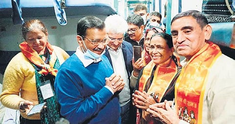 Chief Minister Arvind Kejriwal interacts with pilgrims in the special train. (Photo | Twitter)