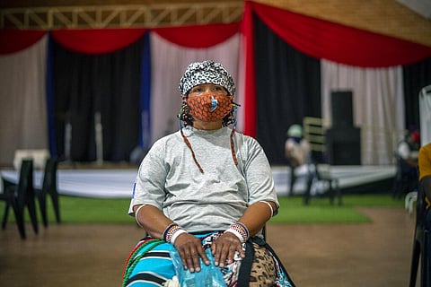 An Orange Farm, South Africa, resident waits for her jab against COVID-19 Friday Dec. 3, 2021 at the Orange Farm multipurpose center. (Photo | AP)