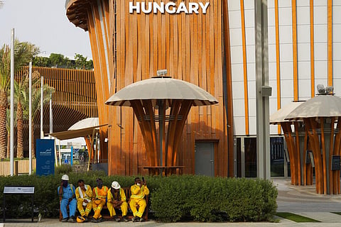 Workers take a break near the Hungary pavilion at Expo 2020 in Dubai, United Arab Emirates. (Photo | AP)