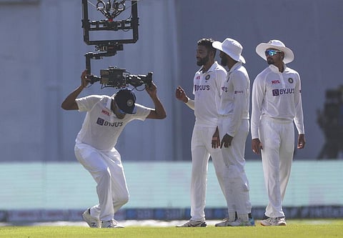 India's Ravichandaran Ashwin, left, plays with Spidercam during the day three of their second test cricket match with New Zealand. (Photo | AP)