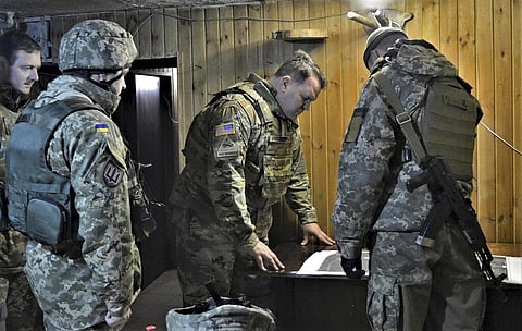 In this photo taken on Nov. 19, 2021, Attache of the Land Forces at the US Embassy in Ukraine Colonel Brandon Presley looks at the map. (Photo | AP)