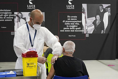 A man receives a dose of the Pfizer COVID-19 vaccine, at a vaccination center set at Rome's Cinecitta' film studio (Photo | AP)