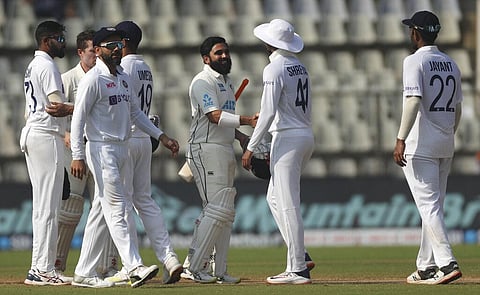 India's player greet New Zealand's Ajaz patel, center, after winning on the day four of their second test cricket match. (Photo | AP)