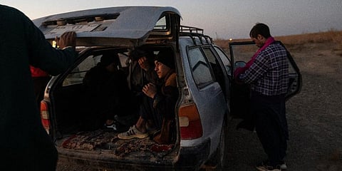 Afghan migrants get in a car near the village of Islam Qala, on Wednesday, Nov. 24, 2021 to drive near the Afghanistan-Iran border in their effort to cross Iran. (Photo | AP)