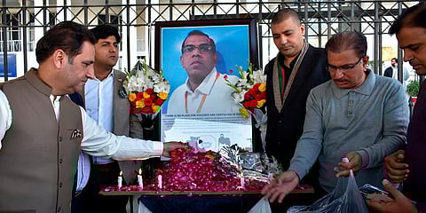 Businessmen put candles and rose petals next to the portrait of the Sri Lankan who was lynched in Pakistan. (Photo| AP)