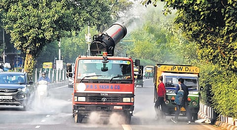 An anti-smog tanker sprays water into the air to reduce dust pollution. (Photo | Parveen Negi)