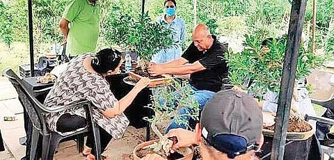 Saumik Das (in black) conducting a bonsai workshop.