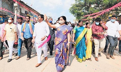 Nizamabad MLC K Kavitha, accompanied by R&B Minister Vemula Prashanth Reddy, waves to locals at Bheemgal town in the district.