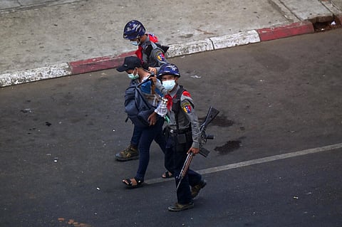 Police arrest Myanmar Now journalist Kay Zon Nwe in Yangon, Myanmar, on February 27, 2021, as protesters were taking part in a demonstration against the military coup. (AFP/Ye Aung Thu)