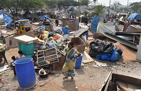 After an earthmover cleared the encroachments at Basavataraka Nagar in Gachibowli on Wednesday, residents of the locality whose houses were demolished try to retrieve their belongings | S Senbagapandi