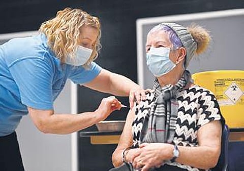 A woman receives a shot of the Oxford/AstraZeneca vaccine in England | AFP