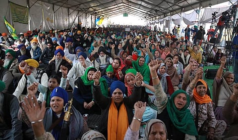 Farmers raise slogans during their ongoing protest against the new farm laws at Singhu border in New Delhi on Sunday. (Photo | Shekhar Yadav/EPS)