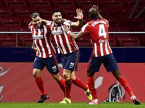 Atletico Madrid's Luis Suarez, center, celebrates with teammates after scoring during a La Liga soccer (Photo | AP)