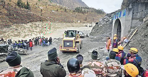 Rescue workers at the entrance of the tunnel in which 37 persons are trapped;