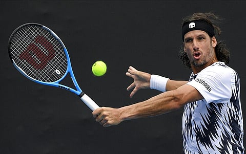 Spain's Feliciano Lopez makes a backhand return to Italy's Lorenzo Sonego during their second round match at the Australian Open (Photo | AP)