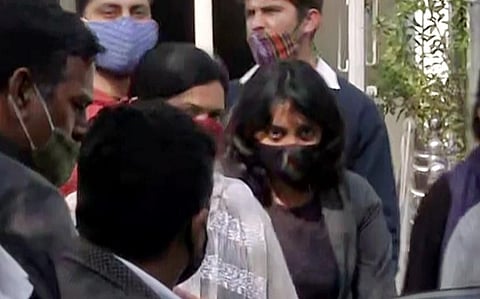Activist Disha Ravi (in black mask) sent to 5 days Delhi police special cell custody, in New Delhi on Sunday. (Photo | ANI)