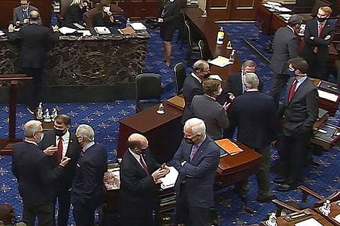 In this image from video, Republican senators and staff talk on the floor after a vote on the motion to allow witnesses in the second impeachment trial of former President Donald Trump. (Photo | AP)