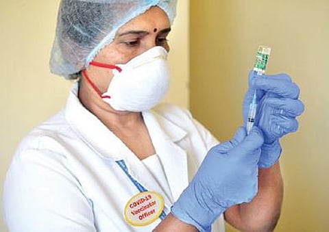 A health worker gets ready for the vaccination drive at a hospital in Bengaluru | Meghana Sastry