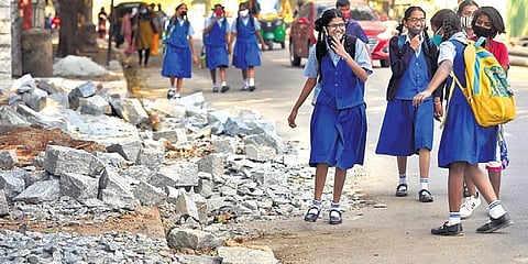 Schoolchildren negotiate debris on a road in Bengaluru | Vinod Kumar T