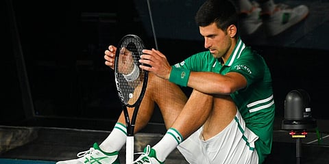 Serbia's Novak Djokovic sits down at the back of the court between games during his quarterfinal against Germany's Alexander Zverev at the Australian Open. (Photo | AP)