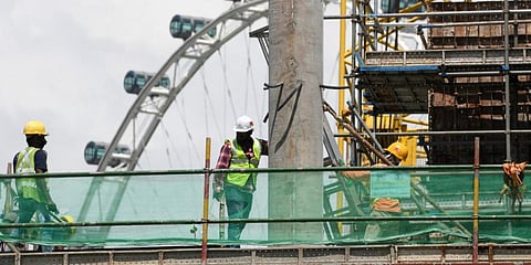 Workers work in a building construction site in Singapore. (File photo| AFP)