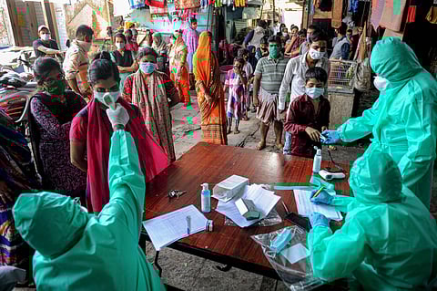 Medics conduct COVID-19 screening of Kumbharwada residents at a camp to curb the spread of coronavirus at Dharavi in Mumbai (File Photo | PTI)