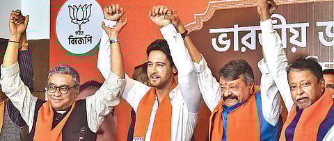 Actor Yash Dasgupta (2nd L) joins hands with BJP leaders in Kolkata. (Photo| PTI)