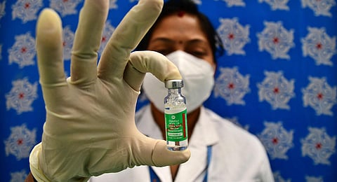 Health official displays a Covishield vaccine at BBMP head office in Bengaluru. (Photo | Shriram BN, EPS)