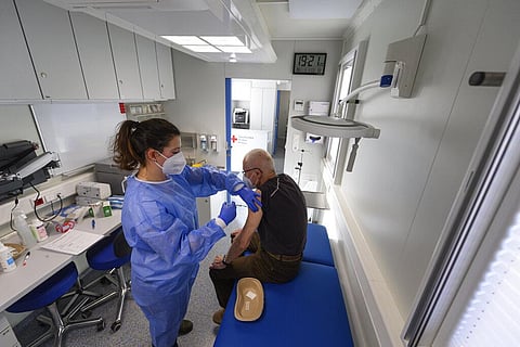 A helper vaccinates a pensioner in a so-called 'rolling vaccination centre', which is in Bannewitz, Germany (Photo | AP)