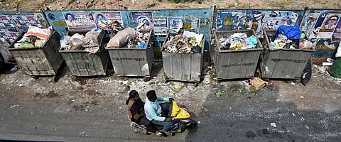 Uncollected garbage rotting in Corporation bins irk commuters at Old Washermenpet. (Photo | P Jawahar, EPS)