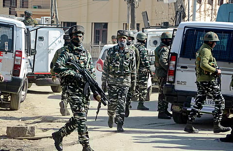 Security personnel conduct a Cordon and Search Operation at Baghat Chowk, after three unidentified militants and a policeman were killed in two separate encounters. (Photo | PTI)