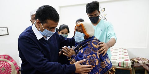 Delhi CM Arvind Kejriwal with the relative of a deceased frontline worker. (Photo| Twitter)