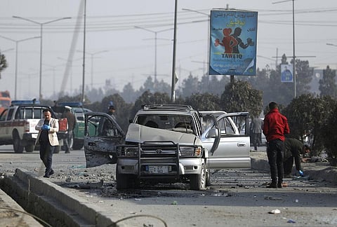 Afghan security personnel inspect the site of a bomb attack in Kabul. (Photo | AP)