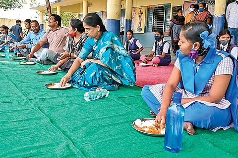 Education Minister Sabitha Indra Reddy has a midday meal with students of a government school at Shivrampally.