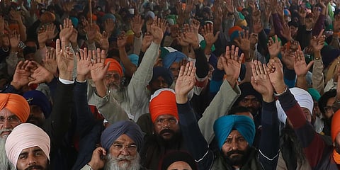 Farmers raise slogans during their ongoing protest at Singhu Border in New Delhi. (Photo| Shekhar Yadav, EPS)