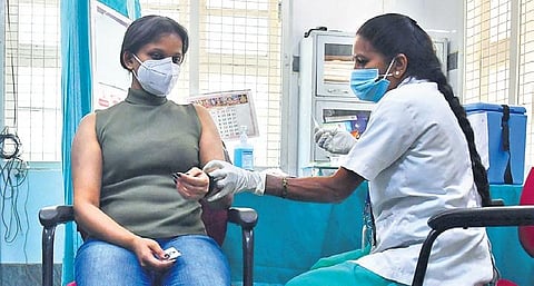 A health worker gets vaccinated with Covishield at Dasappa Hospital | Shriram BN