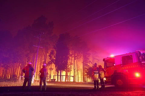 Firefighters attend a fire at Wooroloo, near Perth, Australia, Monday, Feb. 1, 2021. (Photo | AP)