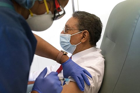 Wallace Charles Smith, 72, who is a pastor at Shiloh Baptist Church, receives his first COVID-19 vaccination by nurse Michelle Martin, at United Medical Center in southeast Washington. (Photo | AP)