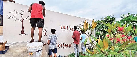 Youngsters help paint tribal art for the cultural musuem coming up in the Nilgiris;