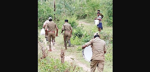A file picture of forest guards driving away elephants at Bandipur National Park.