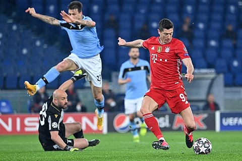 Bayern Munich forward Robert Lewandowski (R) prepares to shoot and open the scoring during the UCL match against Lazio Rome on February 23, 2021 at the Olympic stadium in Rome. (Photo | AFP)