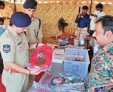 Mulugu police examine the explosives seized from Maoists in Pamunuru forest area on Tuesday