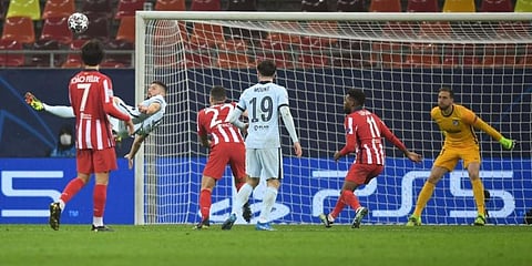 Chelsea's striker Olivier Giroud (L) scores during the UCL match against Club Atletico de Madrid at the Arena Nationala stadium in Bucharest on February 23, 2021. (Photo | AFP)