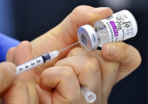 A nurse fills a syringe with the AstraZeneca COVID-19 vaccine. (Photo | AP)